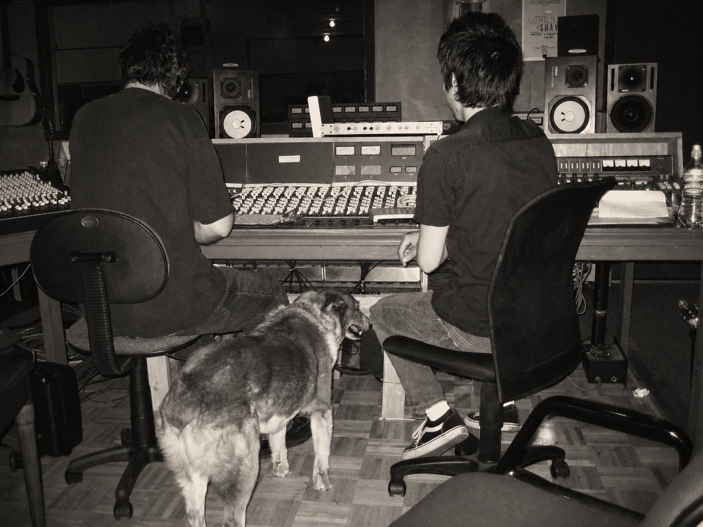 Two musicians and a dog gathered at the studio console during the Giving Up the Ghost sessions in July 2006