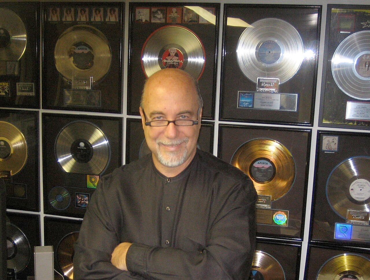 Michael Barbiero standing before his awards in 2007