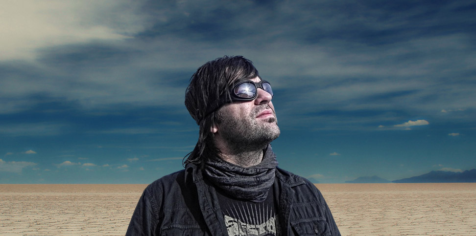 Nathan Dale standing beneath a vast sky in the desert