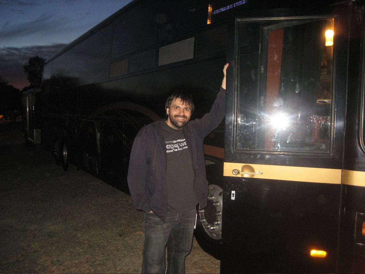 Nathan Dale standing beside the tour bus during his first bus tour in 2009