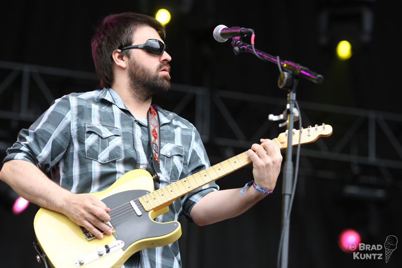 Nathan Dale playing electric guitar with the Jackie Greene Band at Rothbury Festival on July 4, 2009