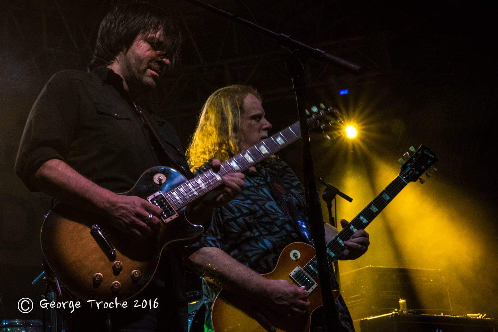 Nathan Dale and Warren Haynes playing electric guitars together onstage in Jamaica in 2016