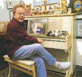 Paul Williams seated at the same piano at O Museum in The Mansion