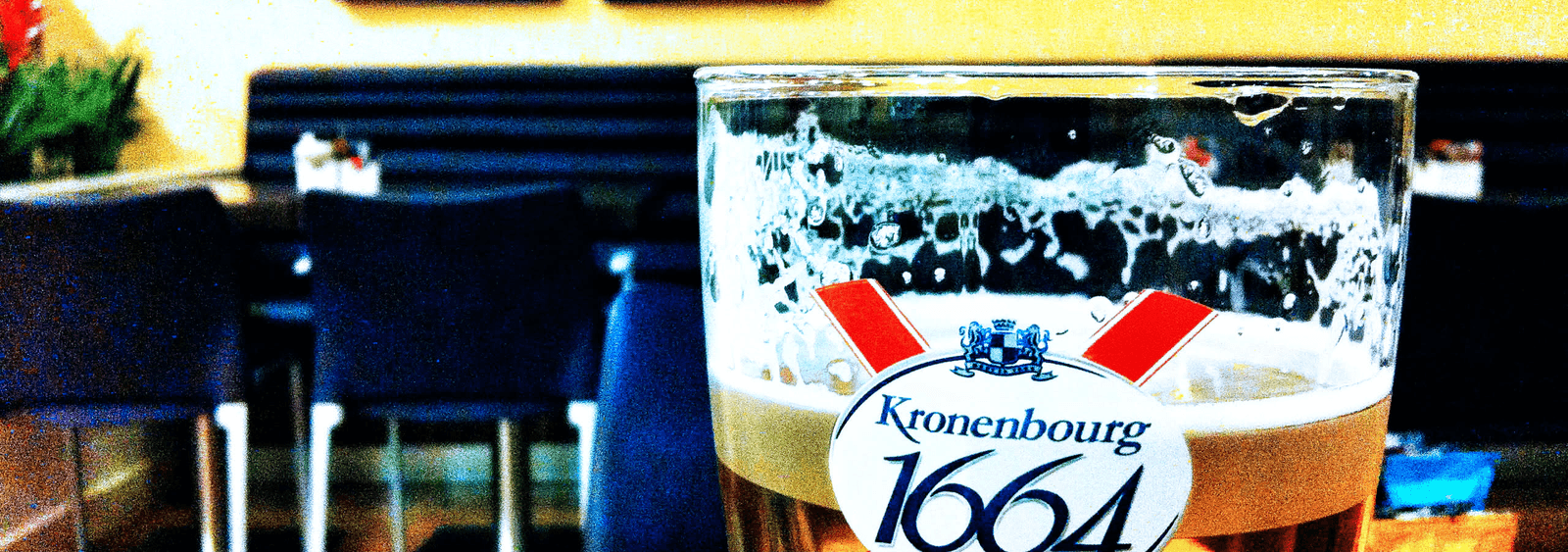 A glass of Kronenbourg 1664 on a café table