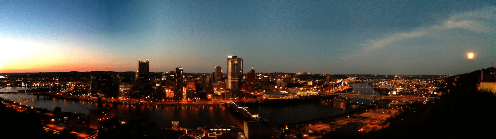 Downtown Pittsburgh and its rivers illuminated at dusk